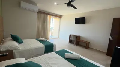 Cama o camas de una habitación en Aeropuerto Express Huatulco