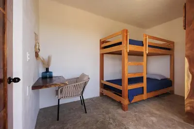 Cama o camas de una habitación en Cozy 2BR Apto Terrace, Pool & AC Steps from Beach