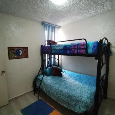 Cama o camas de una habitación en Departamento en Condominio Rocasol