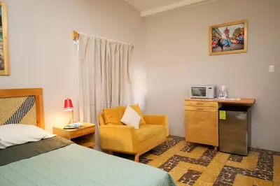 Cama o camas de una habitación en Fresia habitación privada con encanto oaxaqueño