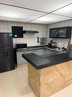 Una cocina o zona de cocina en Hermoso Departamento Moderno con alberca