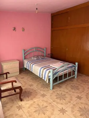 Cama o camas de una habitación en Habitación Estadio GNP