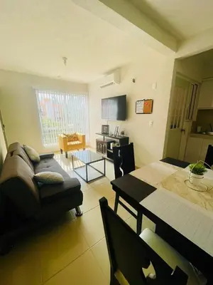 Una televisión o centro de entretenimiento en Acapulco Vibes - Departamento con Alberca Cerca de Punta Diamante