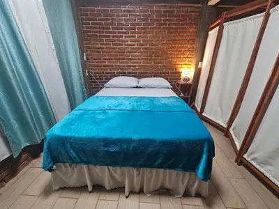 Cama o camas de una habitación en Casa Temazcal Madre Tierra