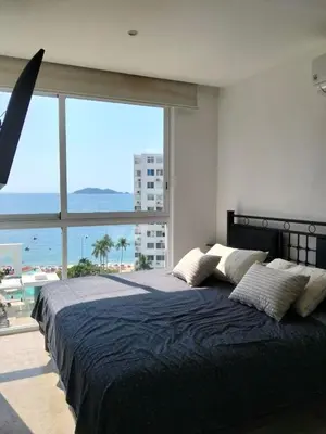 Cama o camas de una habitación en Depa frente al mar en acapulco costera con alberca