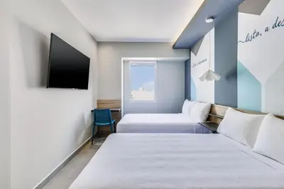 Cama o camas de una habitación en One Acapulco Costera