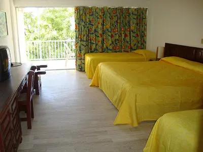 Cama o camas de una habitación en Sands Acapulco Hotel & Bungalows