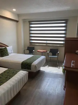 Cama o camas de una habitación en Hotel Aeropuerto