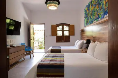 Cama o camas de una habitación en NaNa Vida Hotel Oaxaca