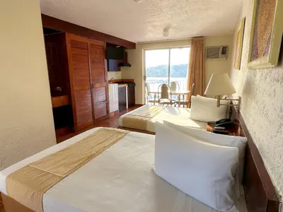 Cama o camas de una habitación en Alba Suites Acapulco