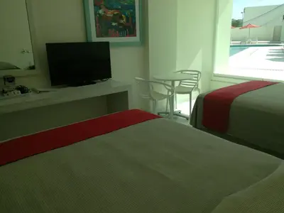 Cama o camas de una habitación en We Hotel Acapulco