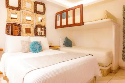 Cama o camas de una habitación en Casa Jaguar Hotel Boutique & Galería