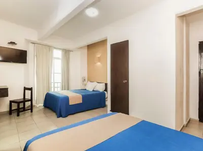 Cama o camas de una habitación en Hotel Trianon