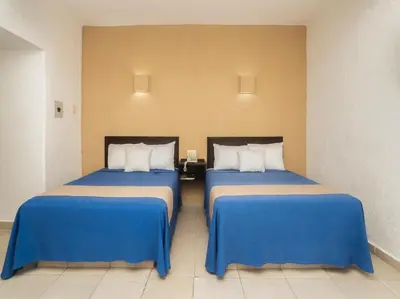 Cama o camas de una habitación en Hotel Trianon