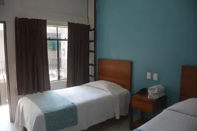 Cama o camas de una habitación en Acapulco Amor