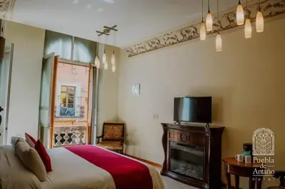 Cama o camas de una habitación en Hotel Puebla de Antaño