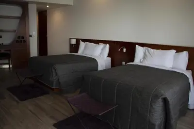 Cama o camas de una habitación en Sonata Hotel Puebla Angelópolis Distrito Sonata