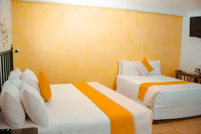 Cama o camas de una habitación en Hotel Oaxaca Real