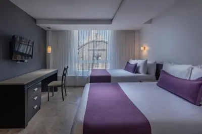 Cama o camas de una habitación en Gamma Puebla Señorial Centro