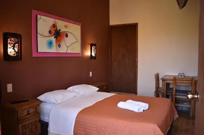 Cama o camas de una habitación en Hotel y Cabañas Quinta Los Cipreses