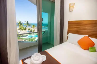 Cama o camas de una habitación en Playa Caracol Hotel & Spa