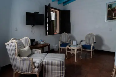Una televisión o centro de entretenimiento en Hotel Boutique Casa de Campo