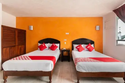 Cama o camas de una habitación en OYO Hotel Casa Blanca