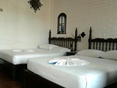 Cama o camas de una habitación en Hotel Paraiso Escondido