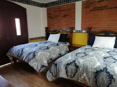 Cama o camas de una habitación en Hotel Y Suites Axolotl