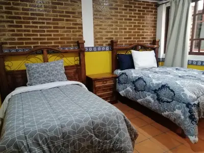 Cama o camas de una habitación en Hotel Y Suites Axolotl