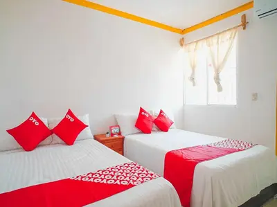 Cama o camas de una habitación en OYO Hospedaje Colibri