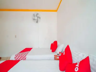 Cama o camas de una habitación en OYO Hospedaje Colibri