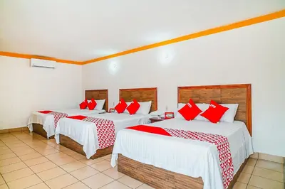 Cama o camas de una habitación en OYO Hospedaje Colibri