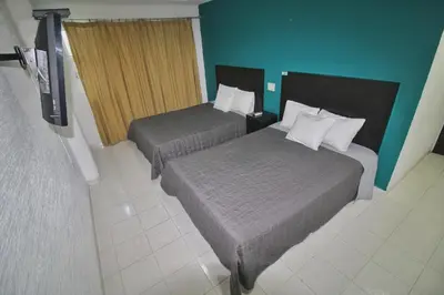 Cama o camas de una habitación en EMS Hoteles Boca del Río