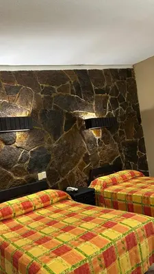 Cama o camas de una habitación en Hotel El Rancho