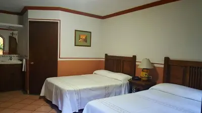 Cama o camas de una habitación en Hotel Posada San Jerónimo