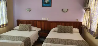 Cama o camas de una habitación en Hotel El Faro Malecon