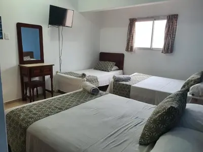 Cama o camas de una habitación en Hotel El Faro Malecon