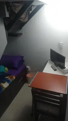 Una televisión o centro de entretenimiento en Division del Norte Rooms