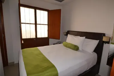 Cama o camas de una habitación en Suites La Concordia