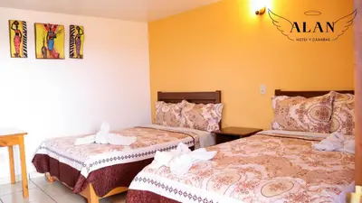 Cama o camas de una habitación en Hotel y Cabañas Alan