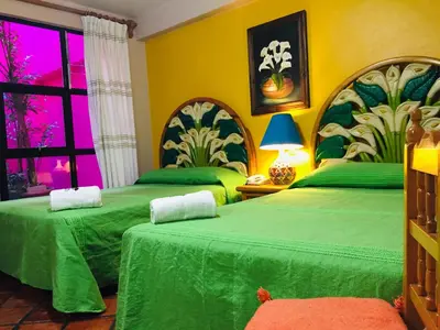 Cama o camas de una habitación en Hotel Cazomalli Oaxaca