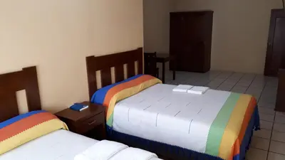 Cama o camas de una habitación en Hotel Alebrijes