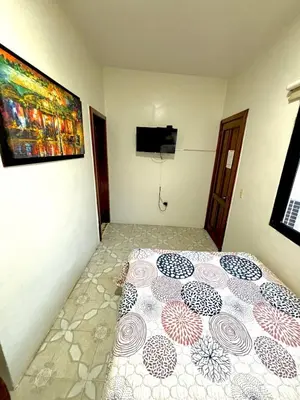 Una televisión o centro de entretenimiento en Hotel Casa Blanca