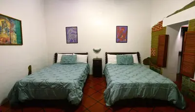 Cama o camas de una habitación en Las Mariposas Hotel & Studios