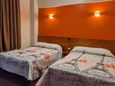 Cama o camas de una habitación en Hotel Edén