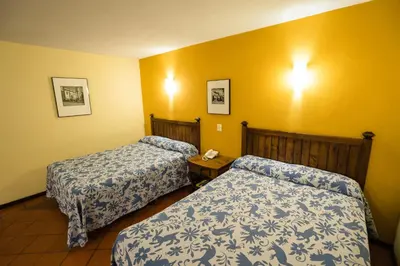 Cama o camas de una habitación en Hotel Real de Naturales