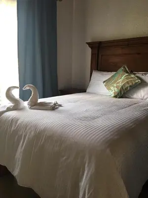 Cama o camas de una habitación en Hotel Concierge Flor y Canto