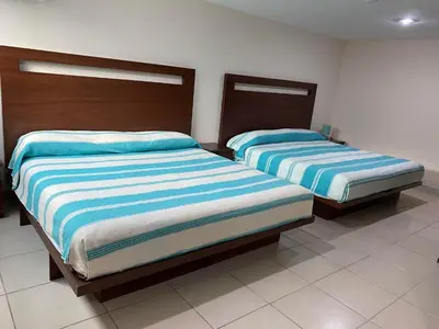 Cama o camas de una habitación en CORDIALITY INN