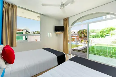 Cama o camas de una habitación en Capital O Hotel El Mejicano, Acapulco